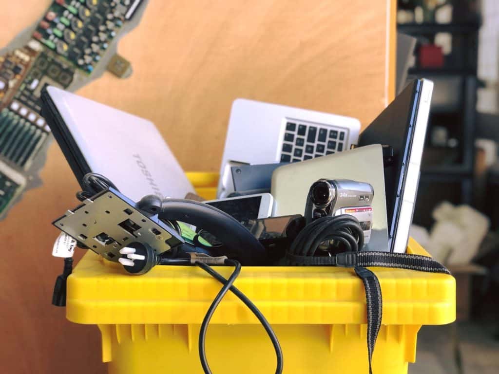 e-waste and gadgets in a disposal bin